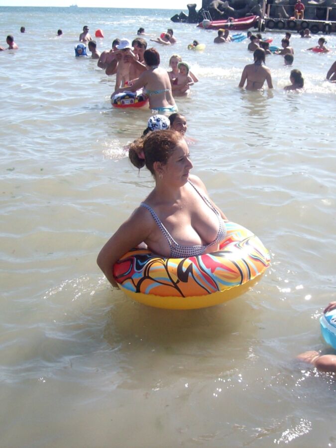 Chubby mother and her busty daughter on the beach