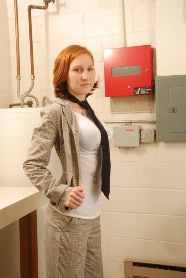 sexy redhead with tattoos doing laundry