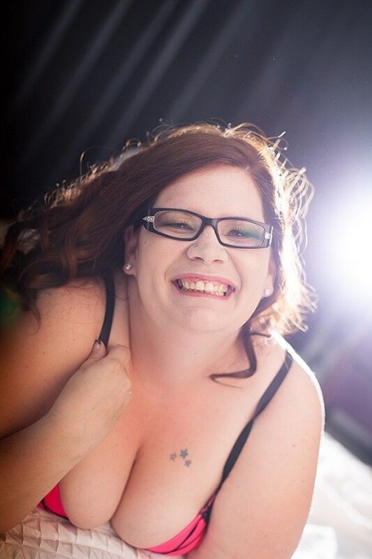 Woman in glasses does boudoir