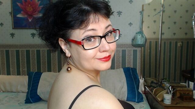 Brunette mature with big tits and glasses