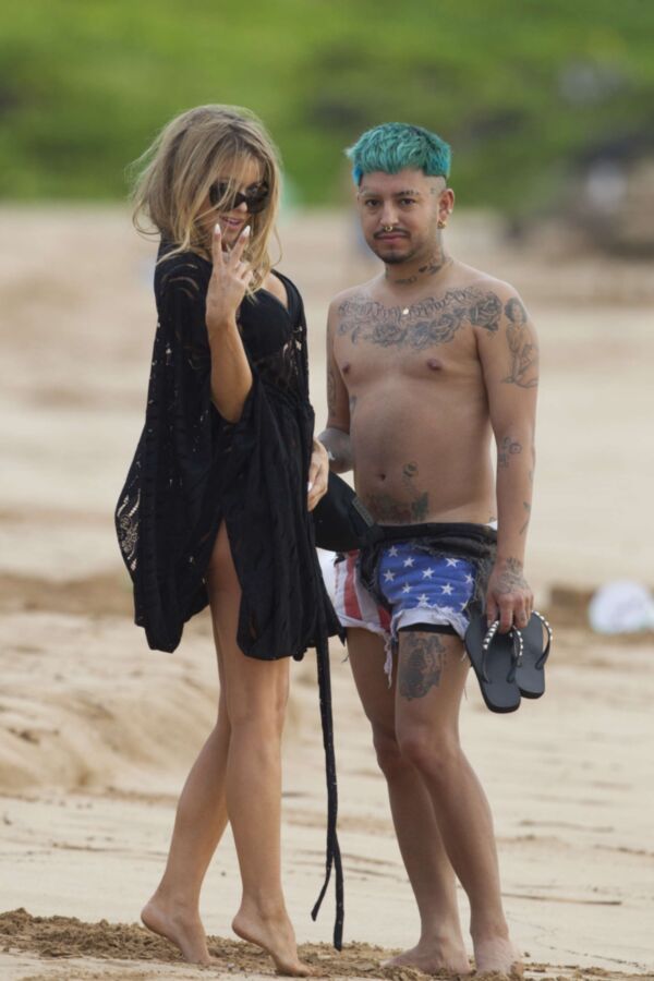 Carmen Electra à la plage se roulant dans le sable