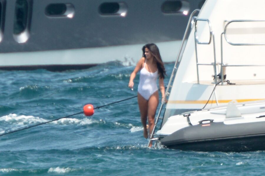 Selena Gomez poking through her one peice