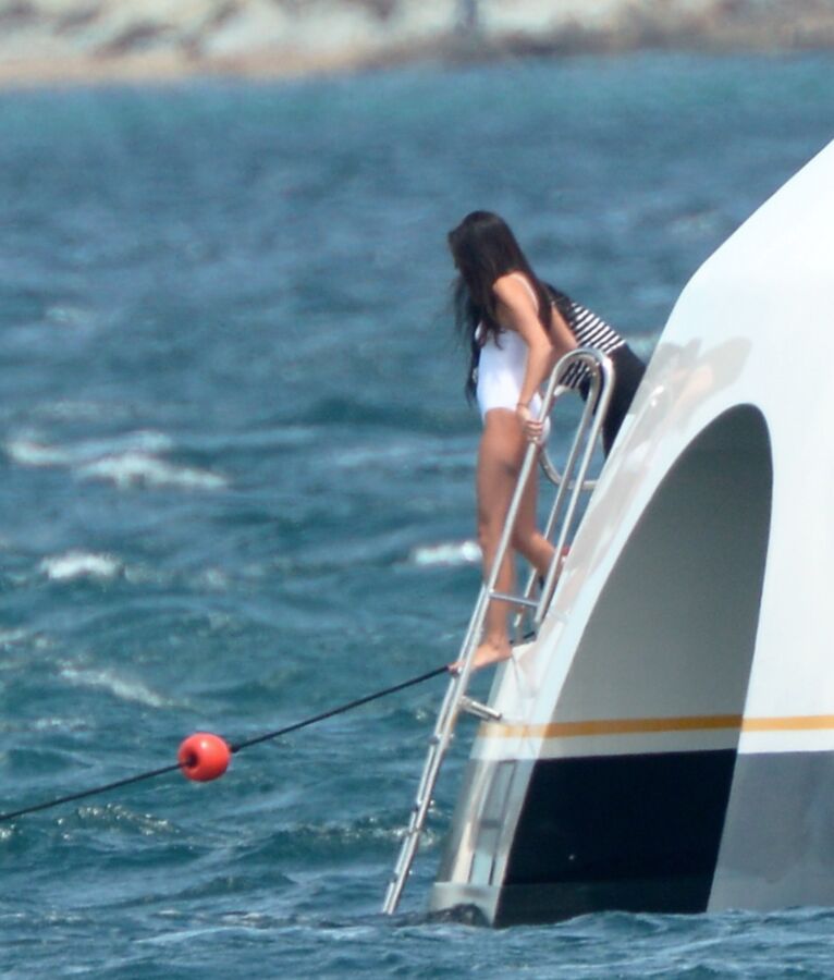 Selena Gomez poking through her one peice