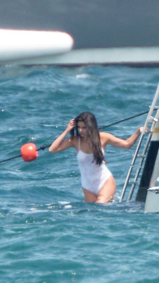 Selena Gomez poking through her one peice