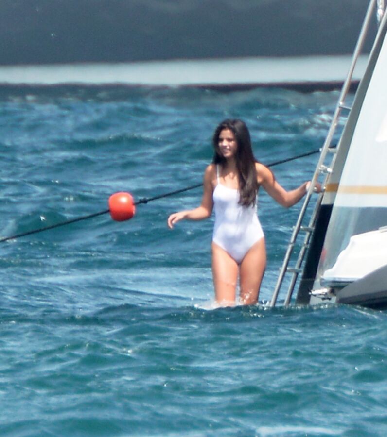 Selena Gomez poking through her one peice