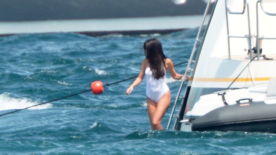 Selena Gomez poking through her one peice