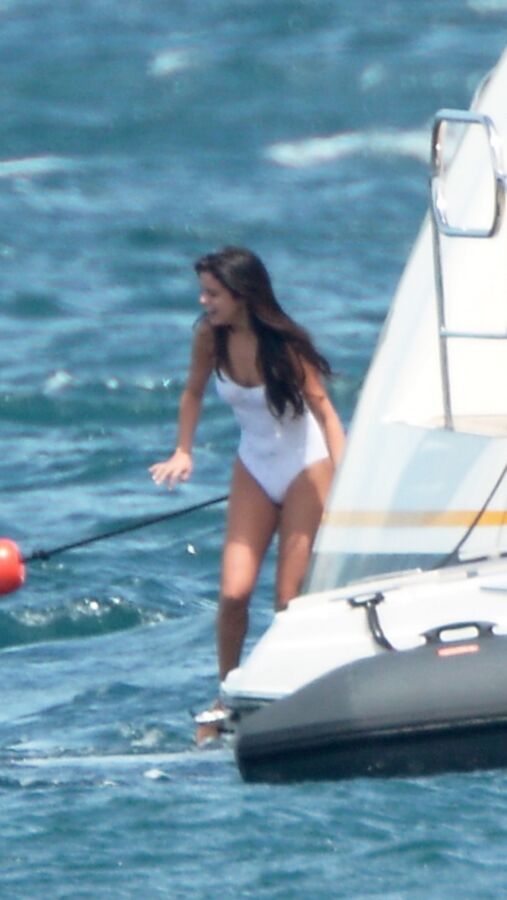 Selena Gomez poking through her one peice