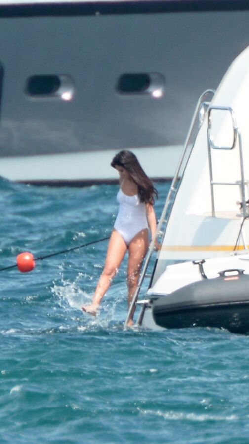 Selena Gomez poking through her one peice