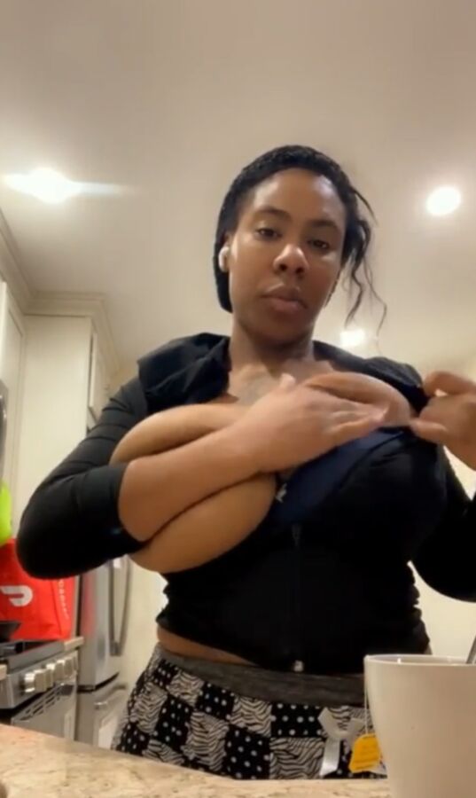 Flashing her big black tits