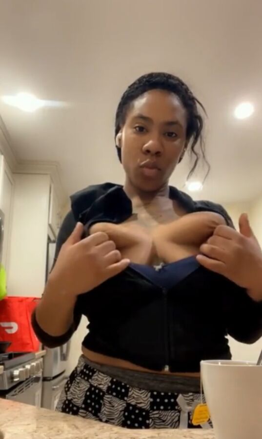 Flashing her big black tits