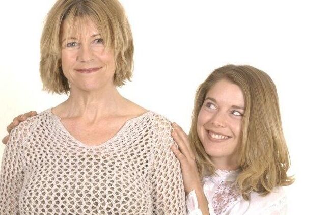 Mom and daughter posing in the studio