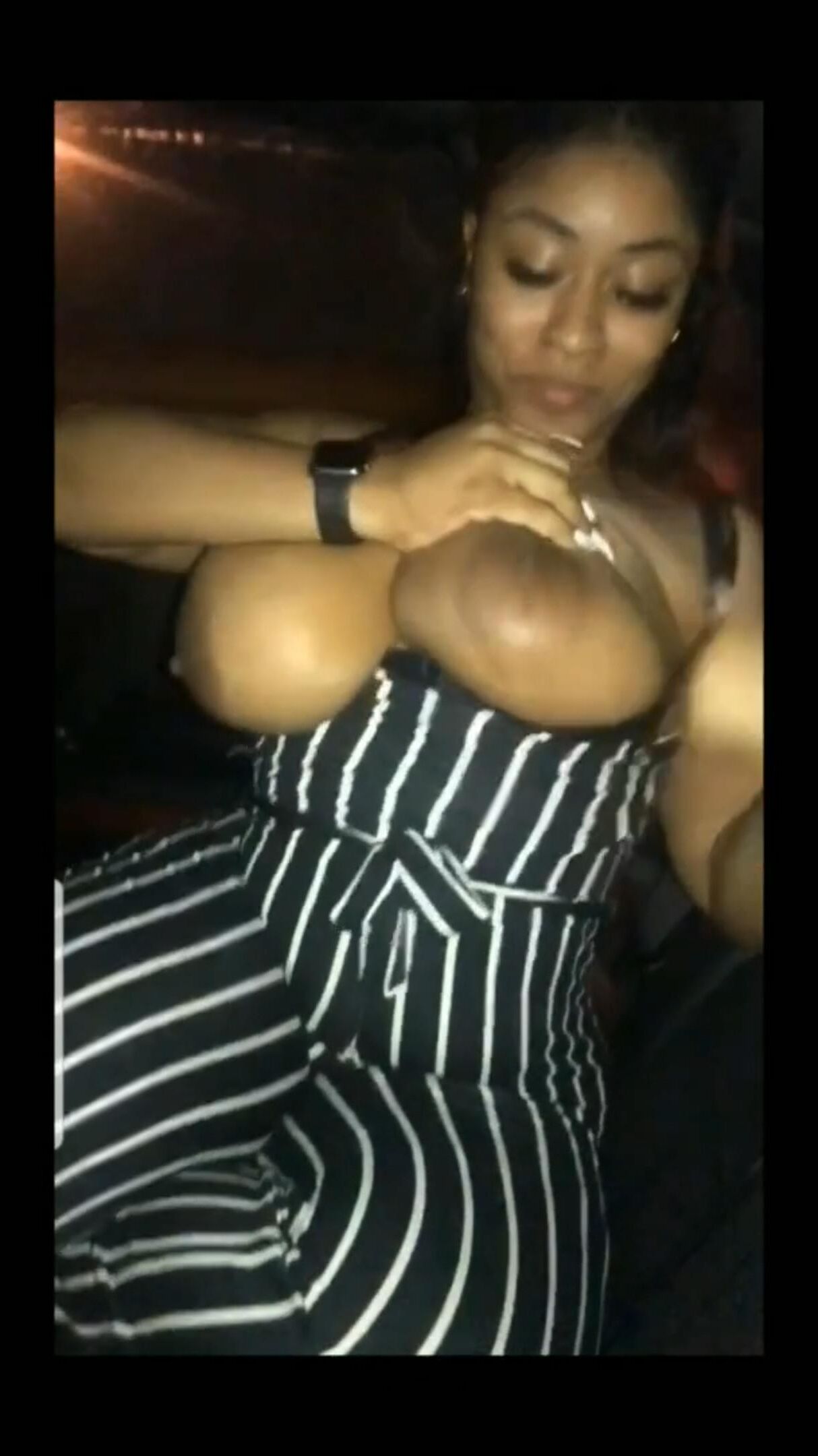 Flashing her big black tits in the car