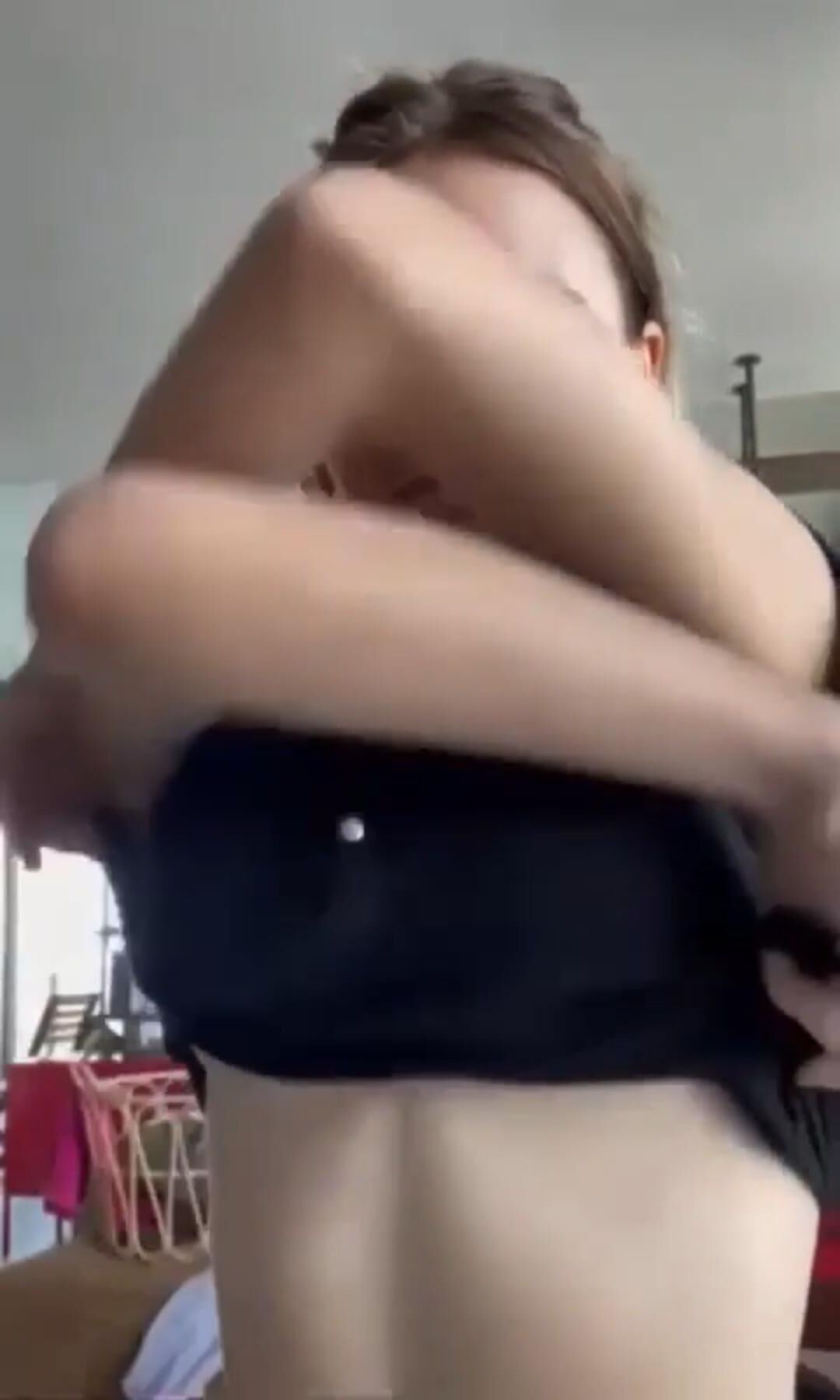 Taking off her top