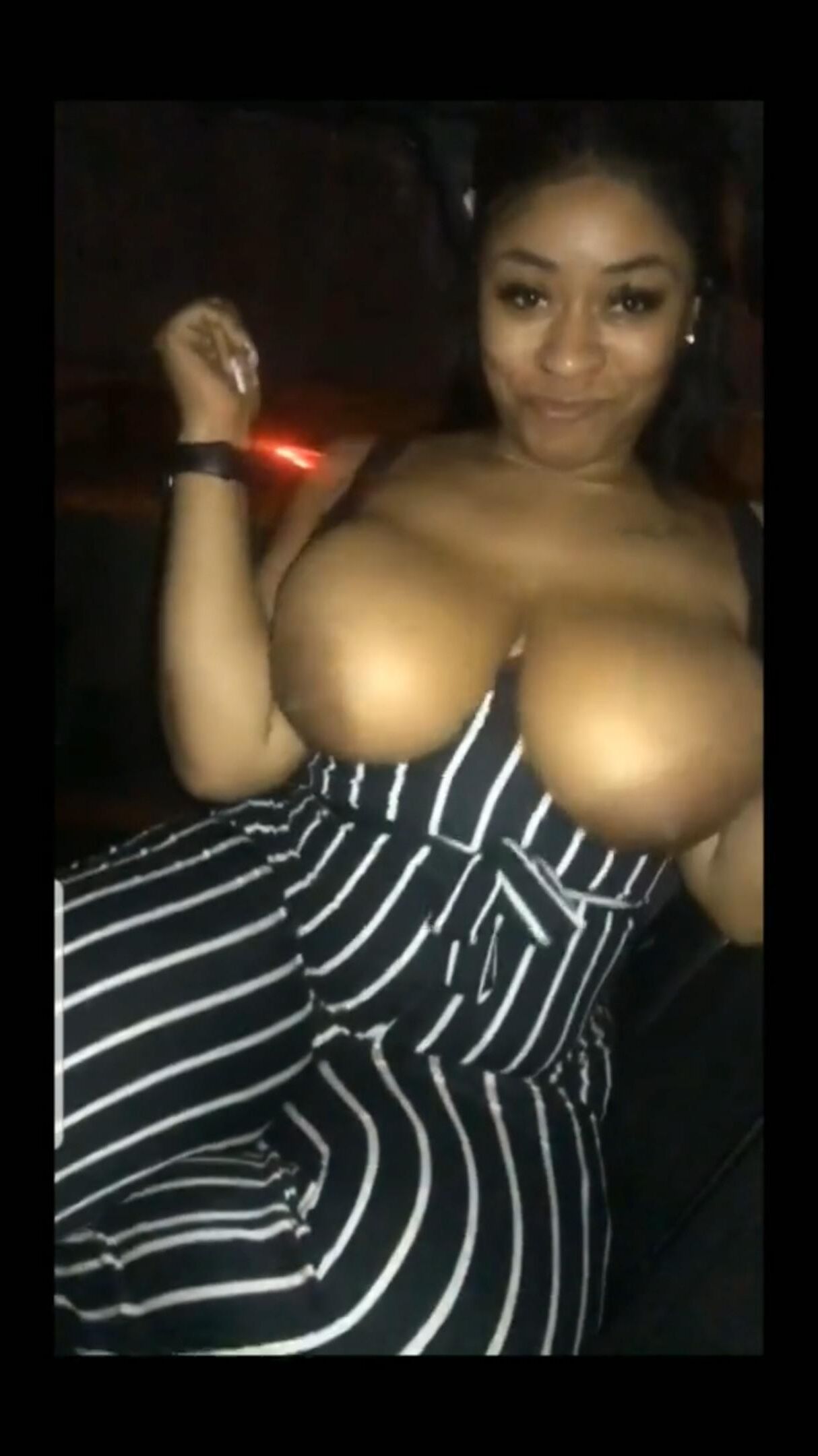 Flashing her big black tits in the car